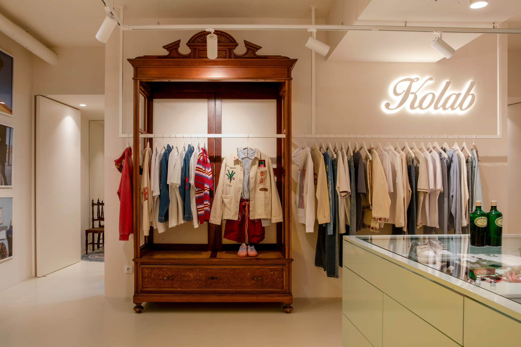 A wooden wardrobe displaying selected clothing inside Kolab